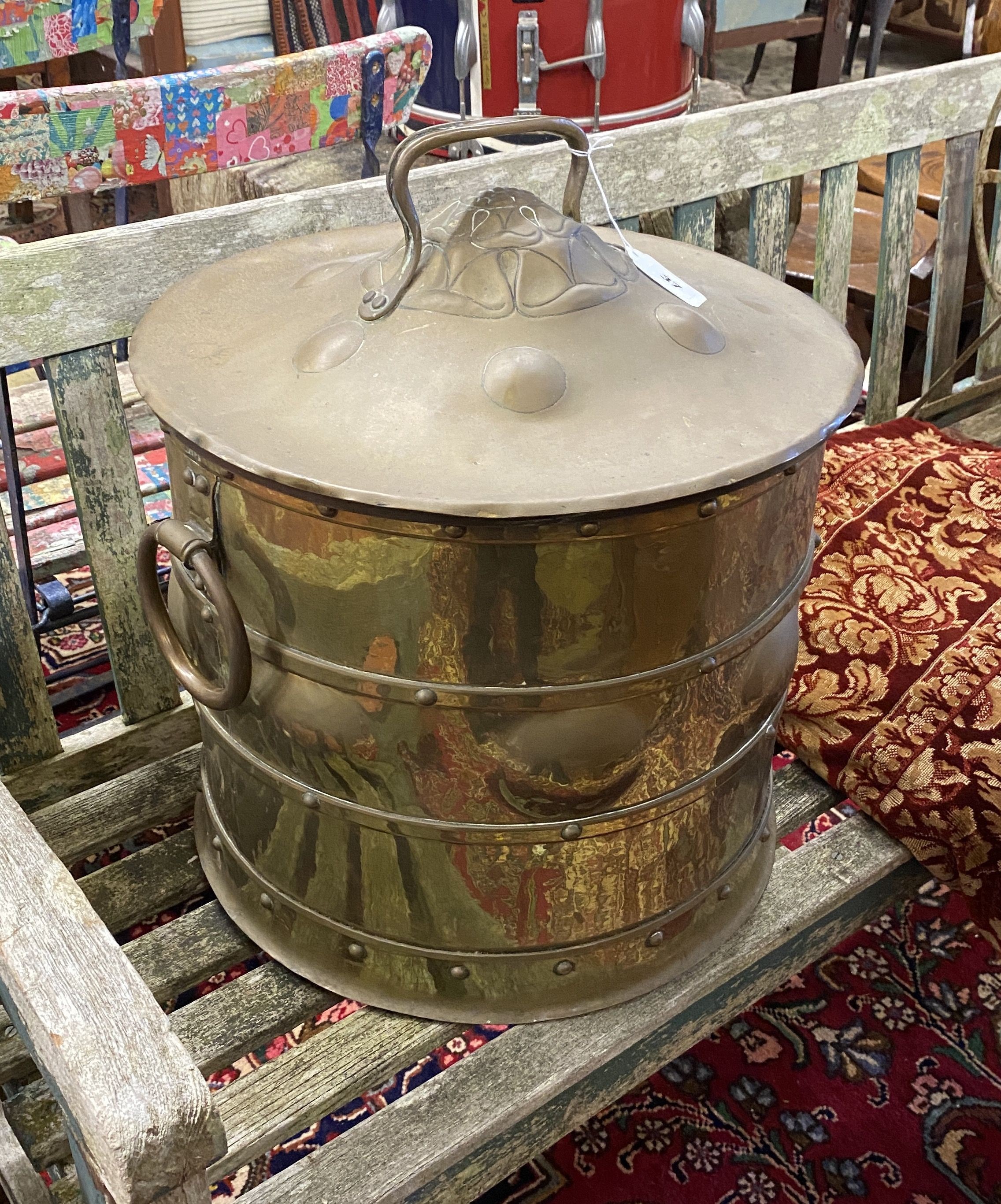 An Arts & Crafts circular embossed brass coal bin, diameter 42cm, height 46cm